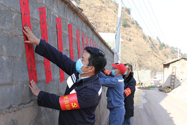 駐村工作隊隊員張貼防疫宣傳標語到各自然村。供圖