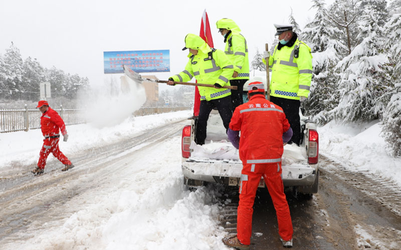 交警与公路卫士的浴“雪”奋战。