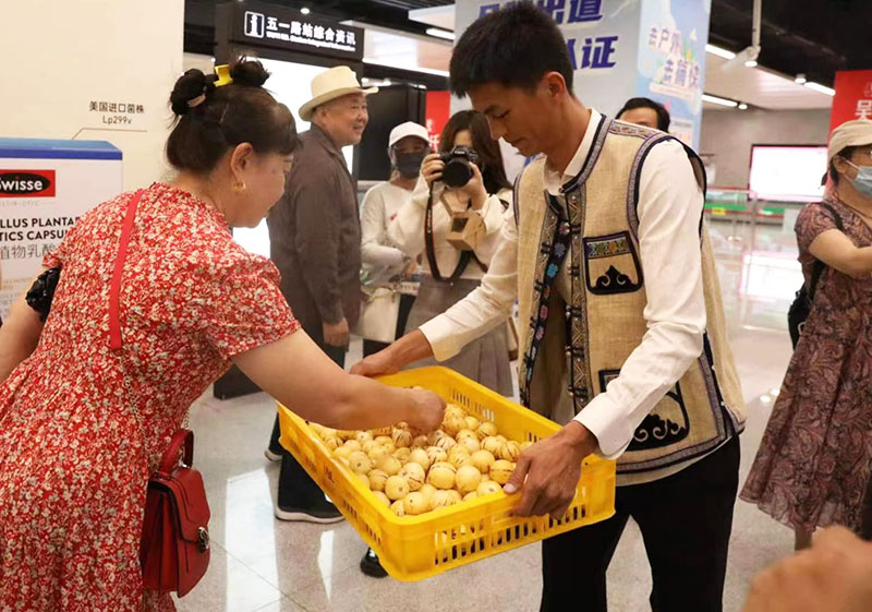 活动现场邀请市民品尝人参果。石林县委宣传部供图