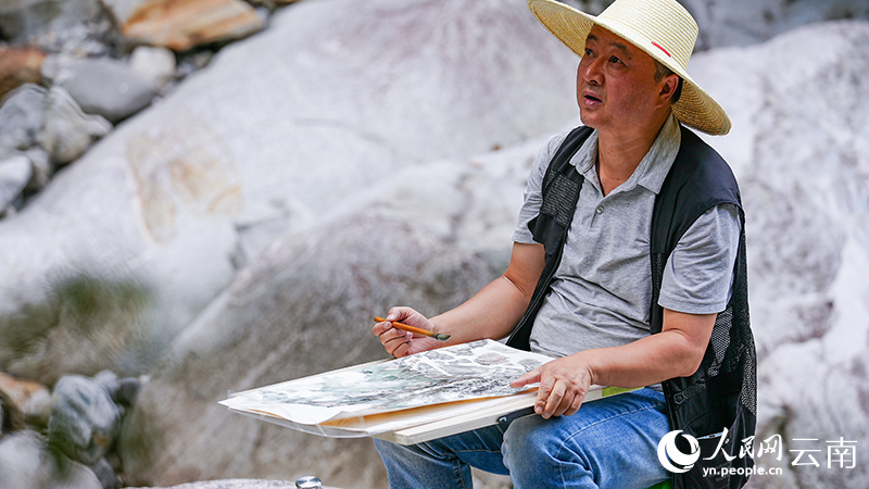 7月23日下午，一名画家正在漾濞县苍山西镇金牛村作画。人民网记者 虎遵会摄