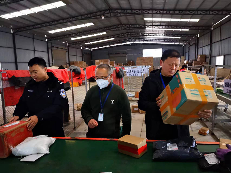 市场稽查员联合公安人员开展快递物流检查。
