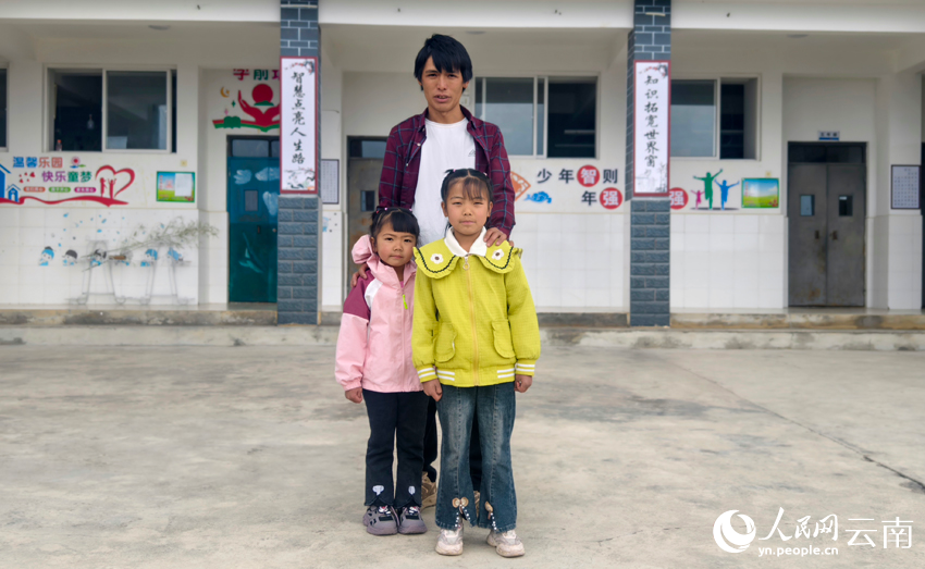 6楊燦彪和兩個女兒在天燈完小教學樓前合影。人民網記者 符皓攝