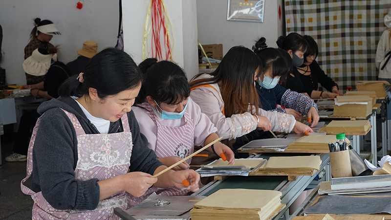 在三岔河镇"家门口的务工车间"，当地群众开展锡箔纸加工。