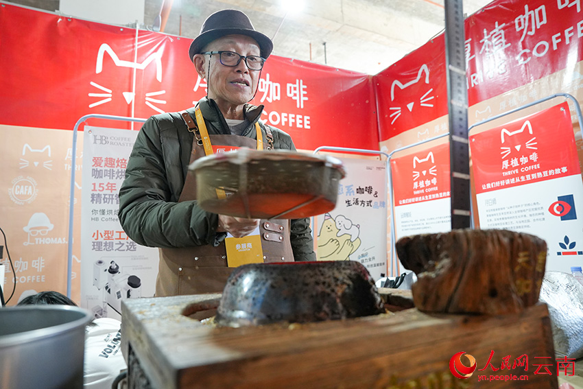 一位参展商在使用传统手法烘焙咖啡豆。人民网记者 虎遵会摄