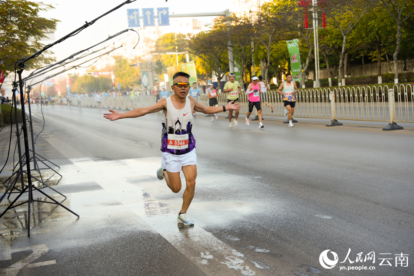 2026普洱思茅馬拉鬆跑者經過噴淋點。人民網 王嫻攝