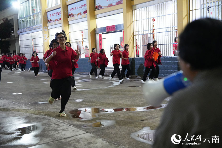 8-1--下晚自习后，同学们向张桂梅跑来。冲在最前面的几个姑娘一头扑进张桂梅怀里，紧紧抱住她深情告白：“张老师，我们爱您！我们舍不得您！”人民网记者-李发兴摄