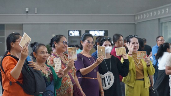 各國旅客在磨丁火車站參加“中老文藝進站點”活動。
